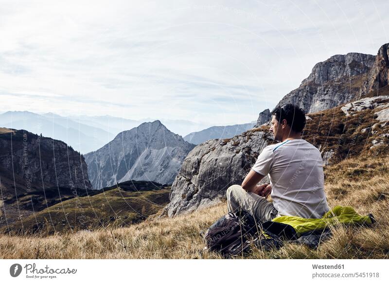Austria, Tyrol, Rofan Mountains, hiker taking a break wanderers hikers Taking a Break resting man men males meadow meadows sitting Seated hiking Adults