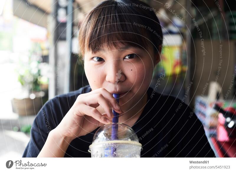 Portrait of woman drinking smoothie portrait portraits Smoothies females women Drink beverages Drinks Beverage food and drink Nutrition Alimentation