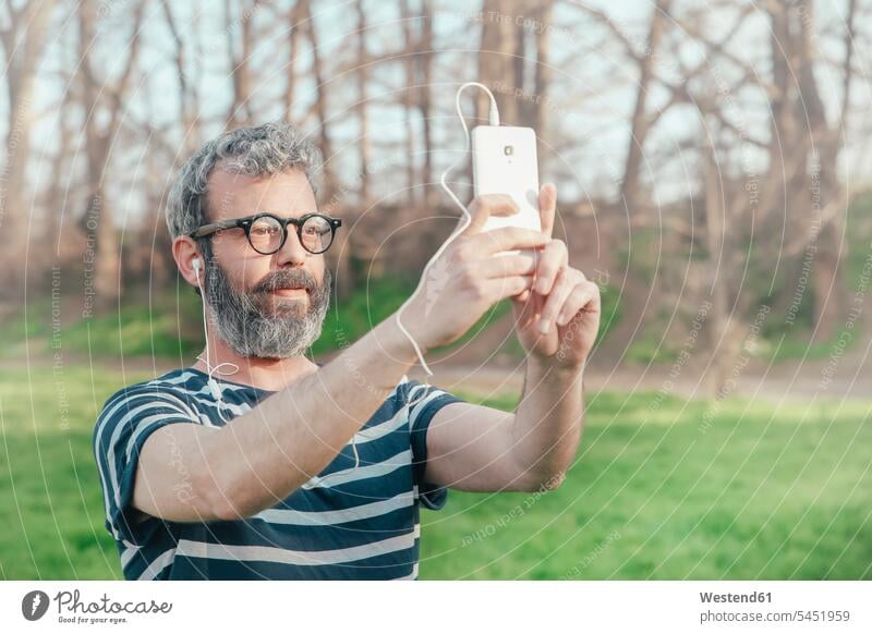 Bearded man taking selfie with smartphone Selfie Selfies men males portrait portraits Adults grown-ups grownups adult people persons human being humans