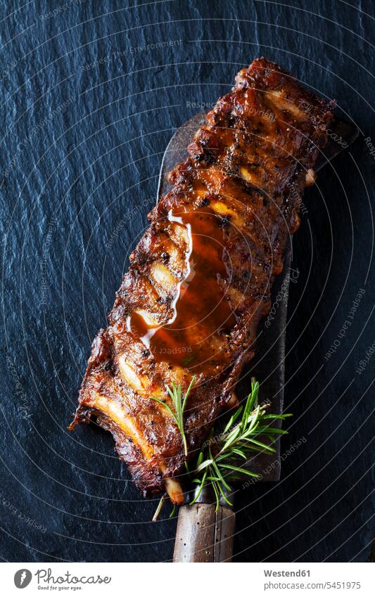 Marinated and grilled spare ribs with Barbecue sauce on slate overhead view from above top view Overhead Overhead Shot View From Above rosemary Garlic