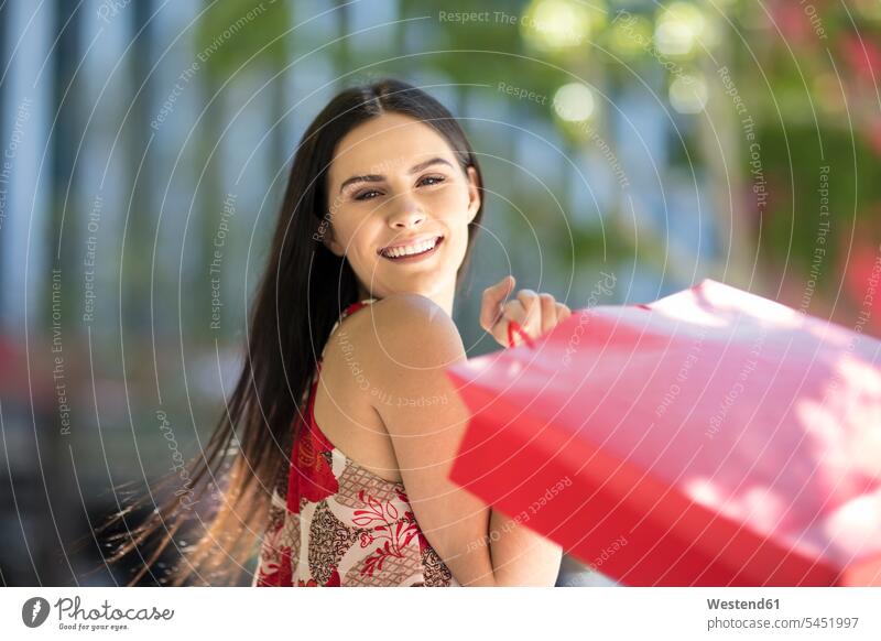 Portrait of happy young woman with shopping bags smiling smile females women shopping-bag shopping-bags happiness buying Adults grown-ups grownups adult people