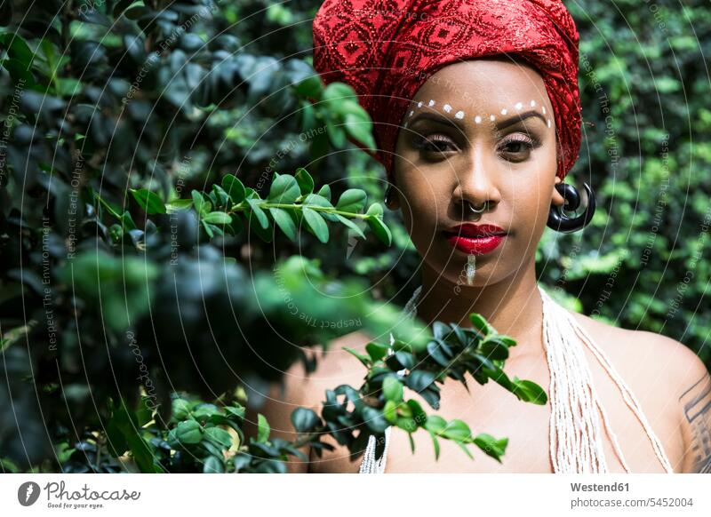 Portrait of young woman with piercings wearing traditional Brazilian headgear headgears headpiece portrait portraits females women Adults grown-ups grownups