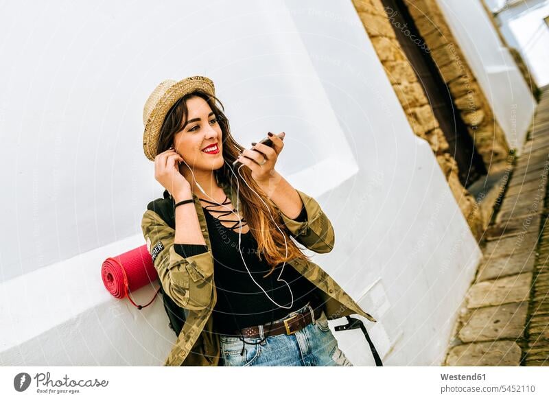 Smiling young traveling woman using cell phone mobile phone mobiles mobile phones Cellphone cell phones talking speaking females women telephones communication