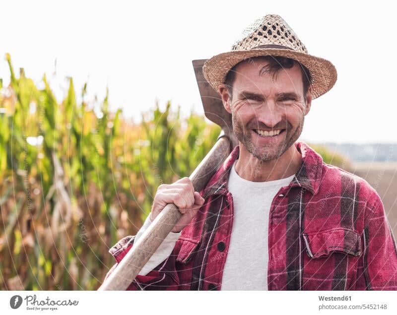 Portrait of happy farmer on field agriculturists farmers man men males portrait portraits smiling smile Field Fields farmland agriculture Adults grown-ups
