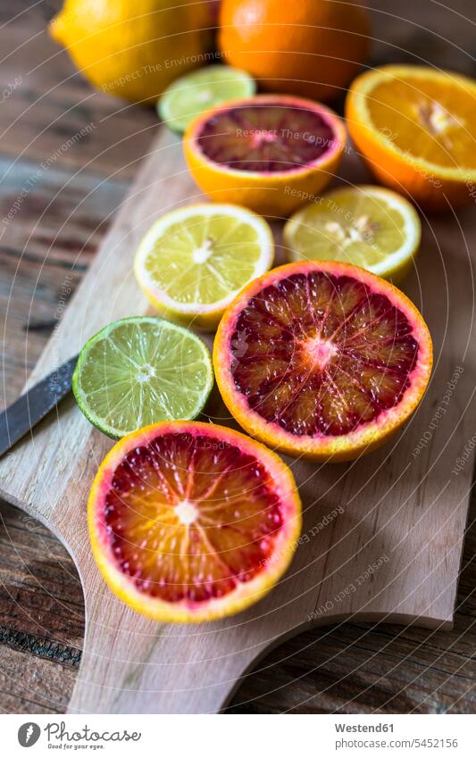 Sliced lemon, oranges and lime on wooden board food and drink Nutrition Alimentation Food and Drinks Orange Citrus sinensis Oranges healthy Lime Lime Fruit
