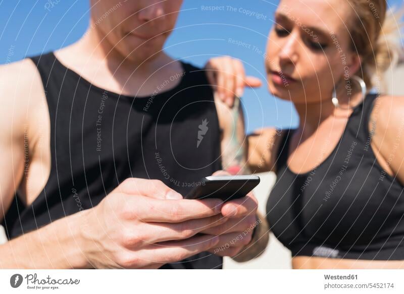 Young couple looking at cell phone, close-up Smartphone iPhone Smartphones hand human hand hands human hands mobile phone mobiles mobile phones Cellphone