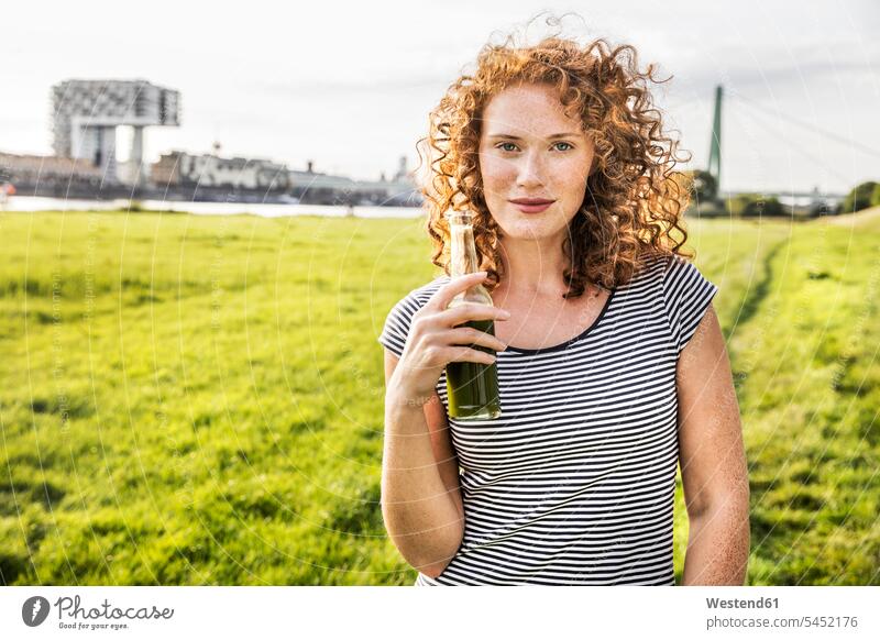 Germany, Cologne, portrait of redheaded young woman with beverage portraits Drink beverages Drinks Beverage females women food and drink Nutrition Alimentation