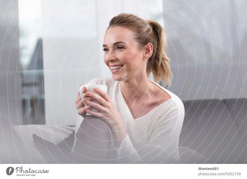 Portrait of happy woman with coffee mug at home females women Coffee Mug Coffee Mugs happiness Adults grown-ups grownups adult people persons human being humans