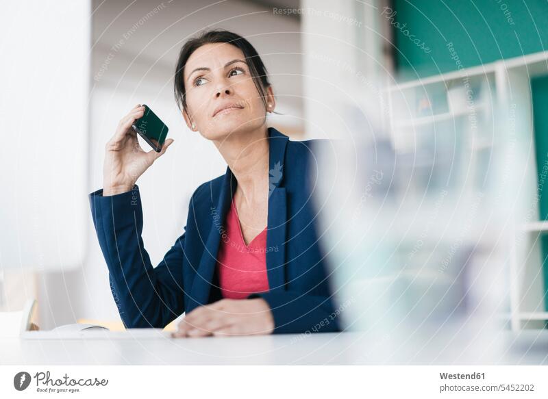 Portrait of smiling businesswoman on the phone businesswomen business woman business women portrait portraits females Smartphone iPhone Smartphones