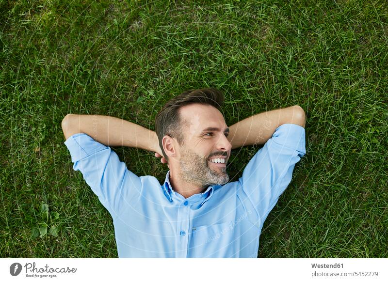 Man relaxing on a meadow, top view meadows lying laying down lie lying down relaxation man men males Adults grown-ups grownups adult people persons human being