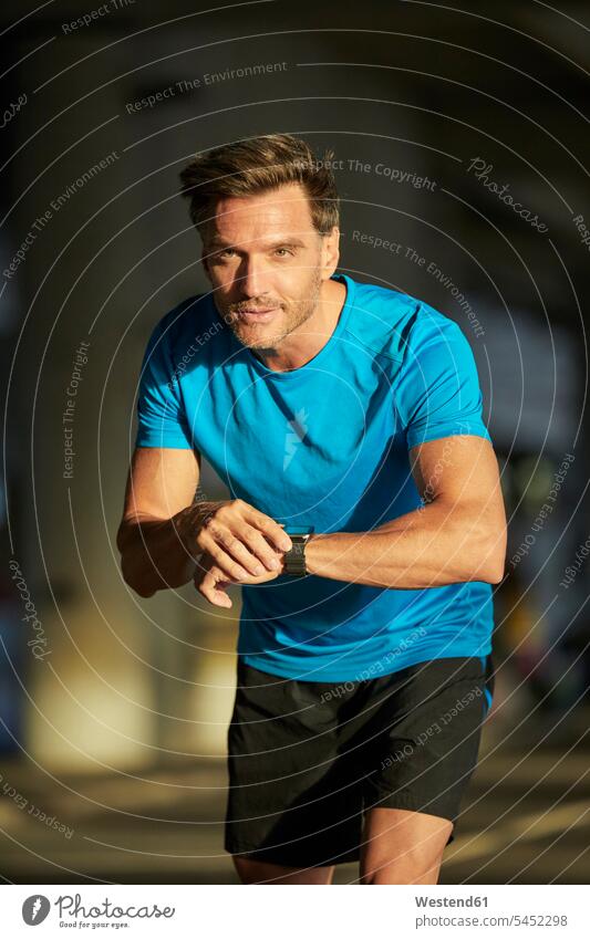 Athlete in the city with smartwatch urban urbanity smart watch athlete Sportspeople Sportsman Sportsperson athletes Sportsmen males Jogging town cities towns