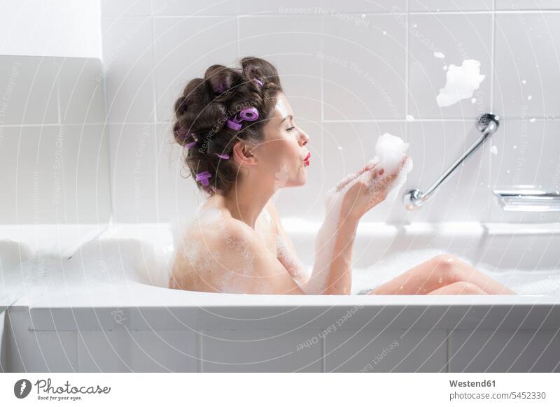 Young woman with curlers taking a bath bathtub tubs bathtubs bath tubs Curler Hair Rollers Hair Curlers Pin Curlers rollers Bubble Bath Foam Baths Bubble Baths