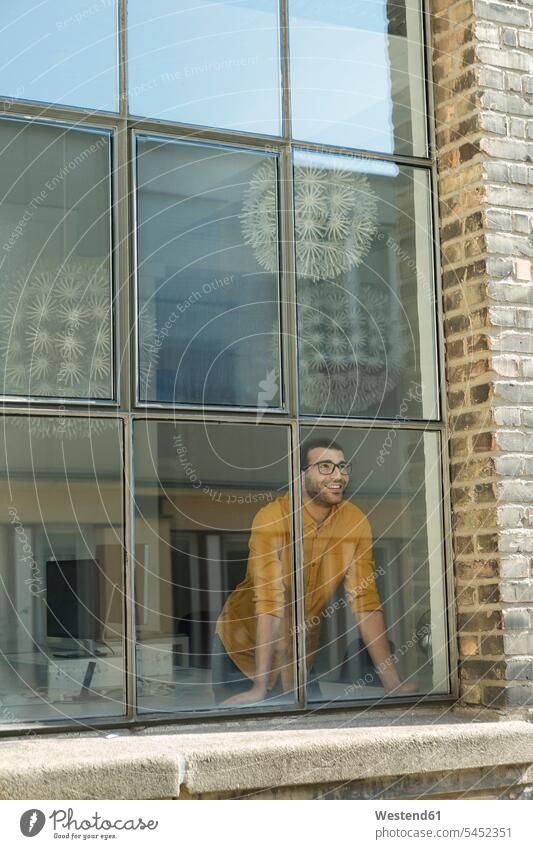 Young professional standing at the window, looking confident young entrepreneur young entrepreneurs start-up entrepreneur Businessman Business man Businessmen