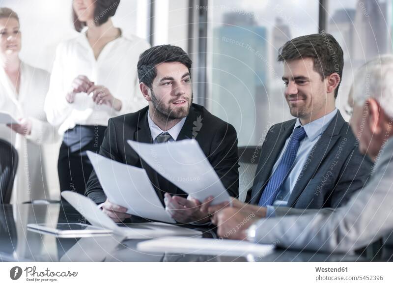Group of businesspeople discussing in meeting colleagues talking speaking office offices office room office rooms Business Meeting business conference