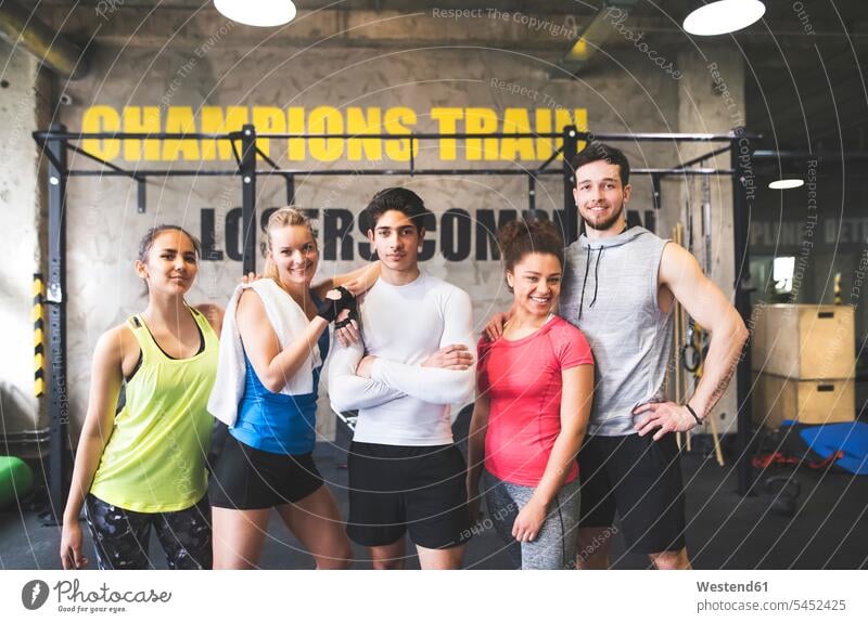 Portrait of confident young people in gym exercising exercise training practising smiling smile portrait portraits gyms Health Club Fitness training fitness