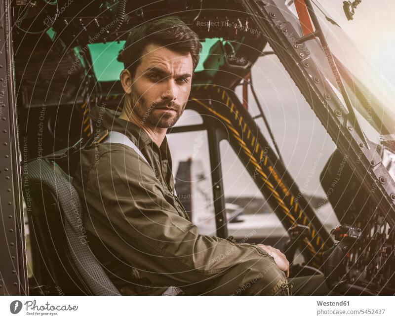 Portrait of pilot in cockpit of a helicopter pilots aircraft Air Vehicle aircrafts Air Vehicles transportation cool attitude composed coolness laid-back man men