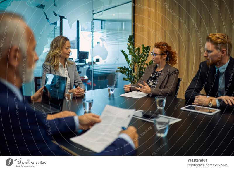 Group of business people discussing in meeting Business Meeting business conference businesspeople office offices office room office rooms talking speaking
