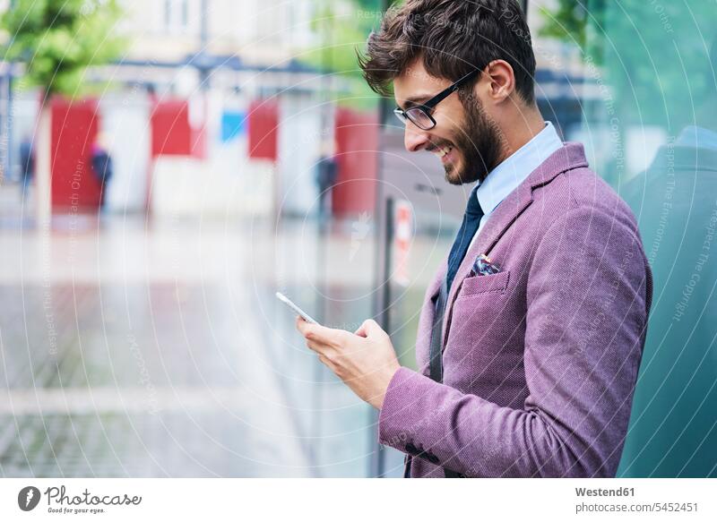 Fashionable businessman checking his cell phone men males Smartphone iPhone Smartphones fashionable Businessman Business man Businessmen Business men Adults