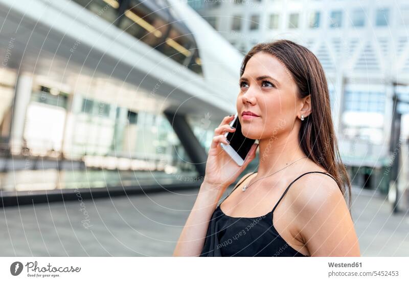 Young woman on the phone in the city call telephoning On The Telephone calling females women mobile phone mobiles mobile phones Cellphone cell phone cell phones
