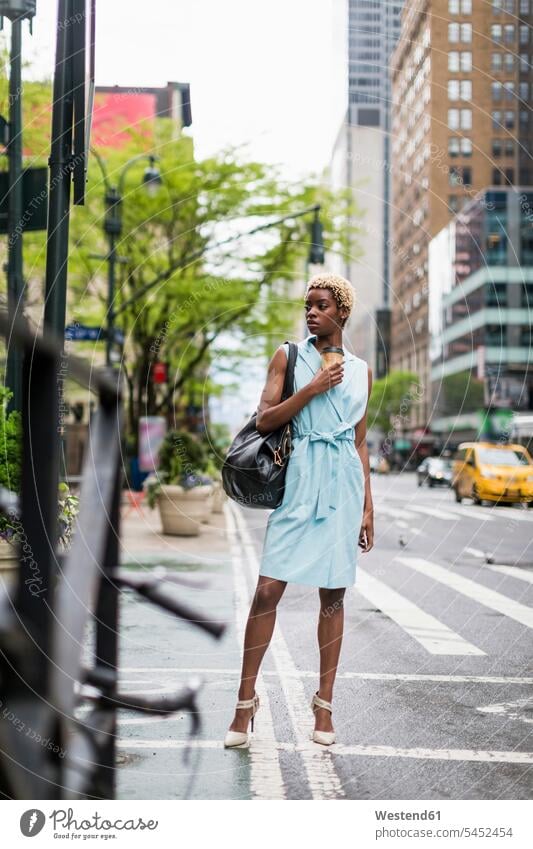 USA, New York, young blonde african-american woman with coffee mug and smart phone mobile phone mobiles mobile phones Cellphone cell phone cell phones fashion