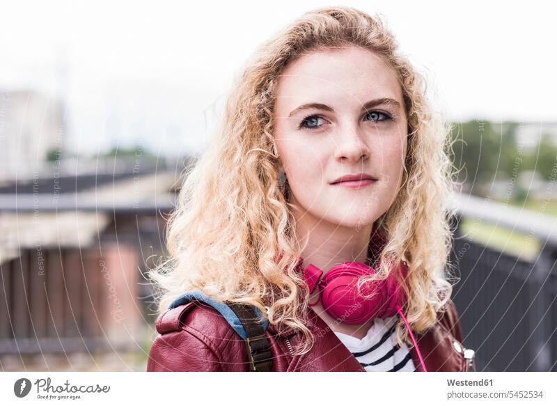 Portrait of young blond woman with pink headphones portrait portraits females women Adults grown-ups grownups adult people persons human being humans