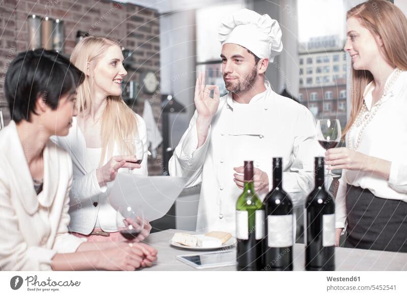 Chef with three women in kitchen cooking course cooking class cooking lesson chef cooks Chefs Red Wine Red Wines Alcohol alcoholic beverage Alcoholic Drink