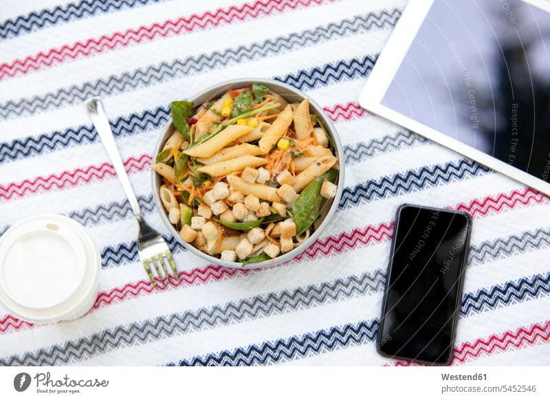 Cell phone, tablet, coffee to go and a bowl of noodle salad on blanket in a park Mobility mobile Smartphone iPhone Smartphones mobile phone mobiles