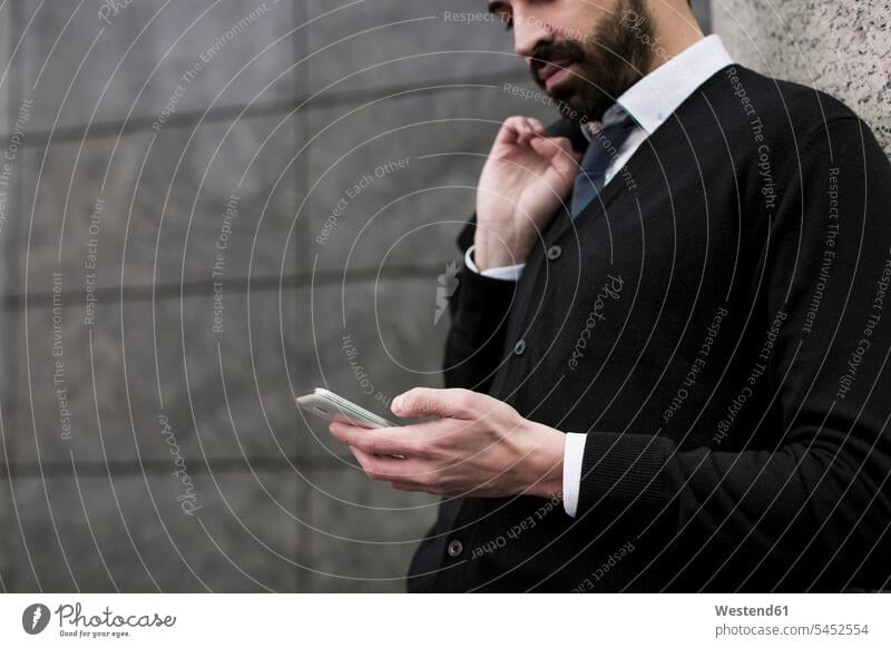Businessman looking at cell phone Business man Businessmen Business men mobile phone mobiles mobile phones Cellphone cell phones business people businesspeople