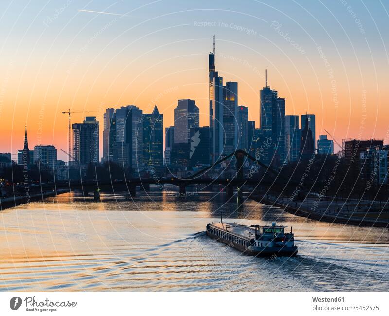 Germany, Frankfurt, view to skyline with Floesserbruecke and Main River in the foreground at morning twilight modern contemporary city cities metropolis