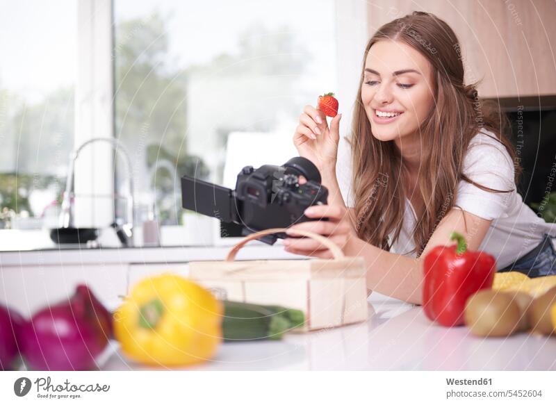 Food blogger filming herself eating strawberry Selfies cameras human human being human beings humans person persons adult grown-up grown-ups grownup grownups