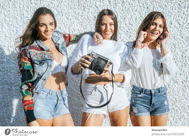 Group picture of three friends having fun together photographing group picture Group Portrait group foto female friends camera cameras portrait portraits mate