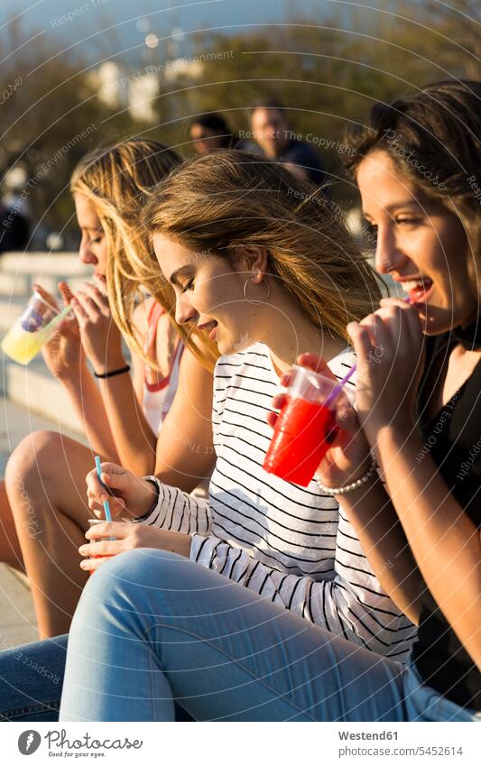 Three young women with soft drinks at sunset female friends Drink beverages Drinks Beverage drinking mate friendship food and drink Nutrition Alimentation