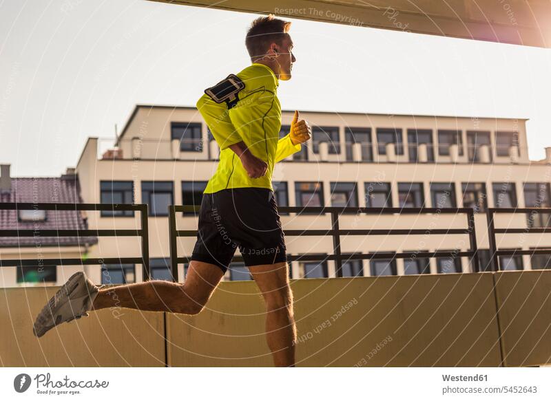 Young man running on parking level urban urbanity training Sport Training endurance young athlete Sportspeople Sportsman Sportsperson athletes Sportsmen fit