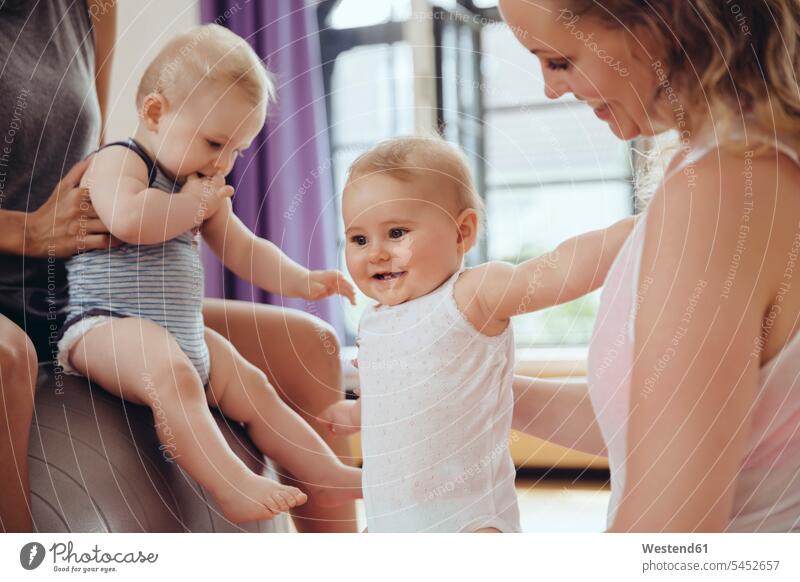 Mothers and babies in exercise room mother mommy mothers ma mummy mama exercising training practising smiling smile baby infants nurselings Fun having fun funny