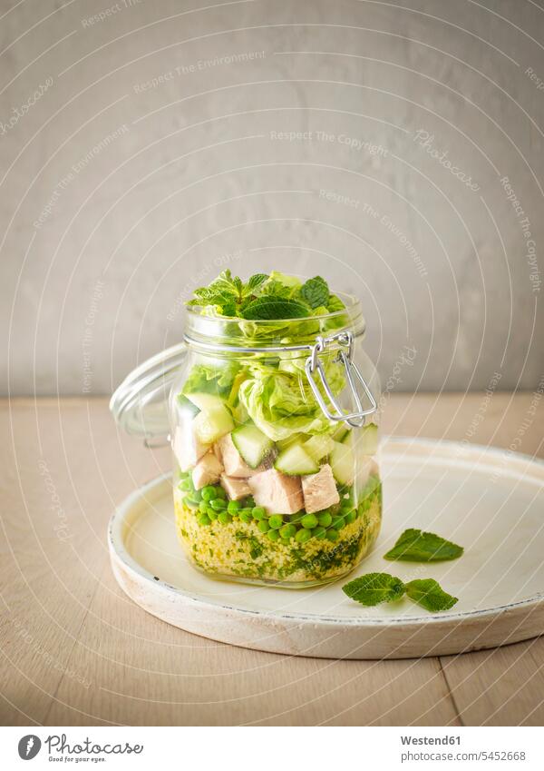 Preserving jar of Couscous salad with peas, cucumber and diced boiled chicken takeaway food Take Away Food couscous marinade Pepper mint peppermint