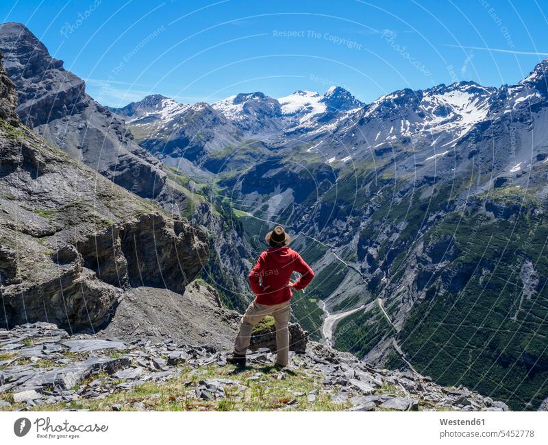 Italy, Lombardy, Sondrio, hiker resting with view to Stelvio Pass and Ortler Cancano nature natural world View Vista Look-Out outlook hand on hip Hand On Hips