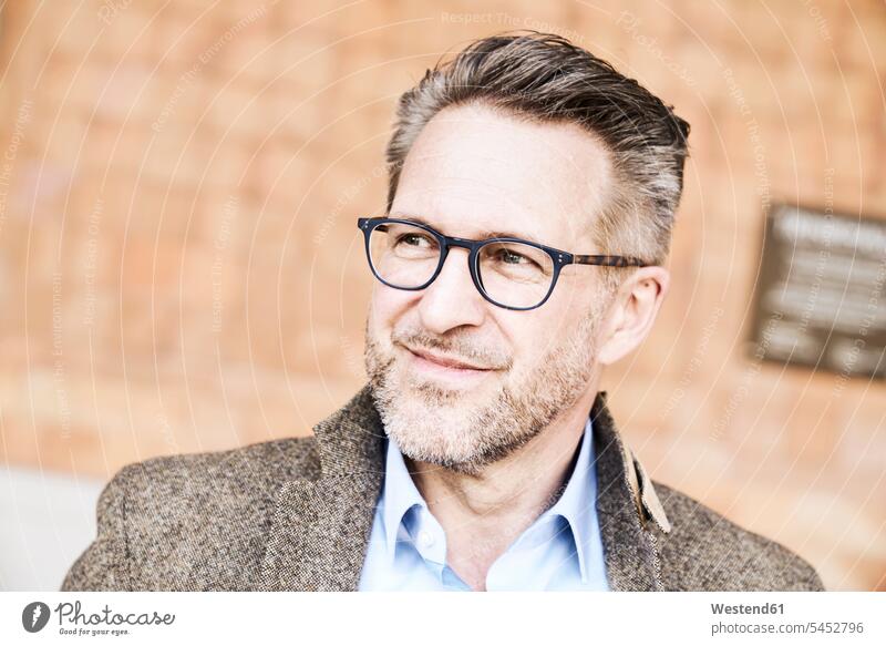Portrait of smiling man with stubble wearing glasses men males portrait portraits Adults grown-ups grownups adult people persons human being humans human beings