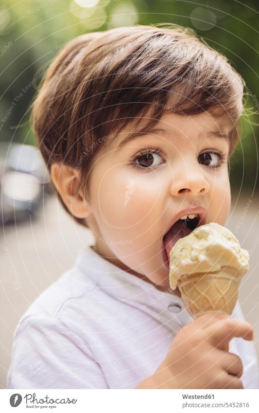 Portrait of toddler eating vanilla ice cream in park portrait portraits boy boys males child children kid kids people persons human being humans human beings