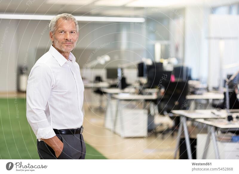 Portrait of confident businessman in office offices office room office rooms Businessman Business man Businessmen Business men portrait portraits workplace