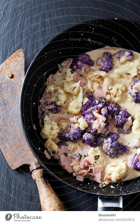 Pan of cauliflower florets with cooked ham and spices in cream sauce food and drink Nutrition Alimentation Food and Drinks Ham Part Of partial view cropped