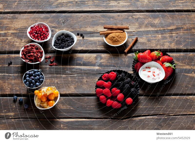 Various dried and fresh fruits and bowl of cinnamon powder with cinnamon sticks on wood food and drink Nutrition Alimentation Food and Drinks chokeberry