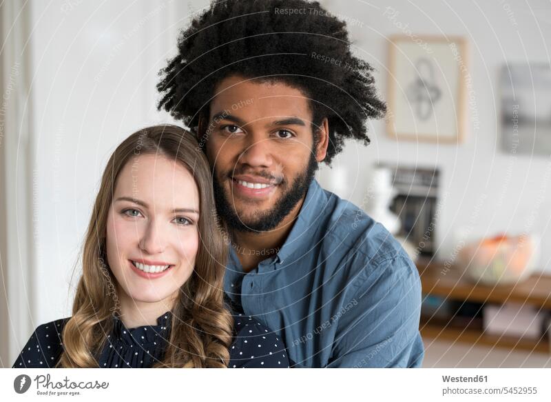 Portrait of smiling couple looking in camera twosomes partnership couples portrait portraits home at home smile people persons human being humans human beings