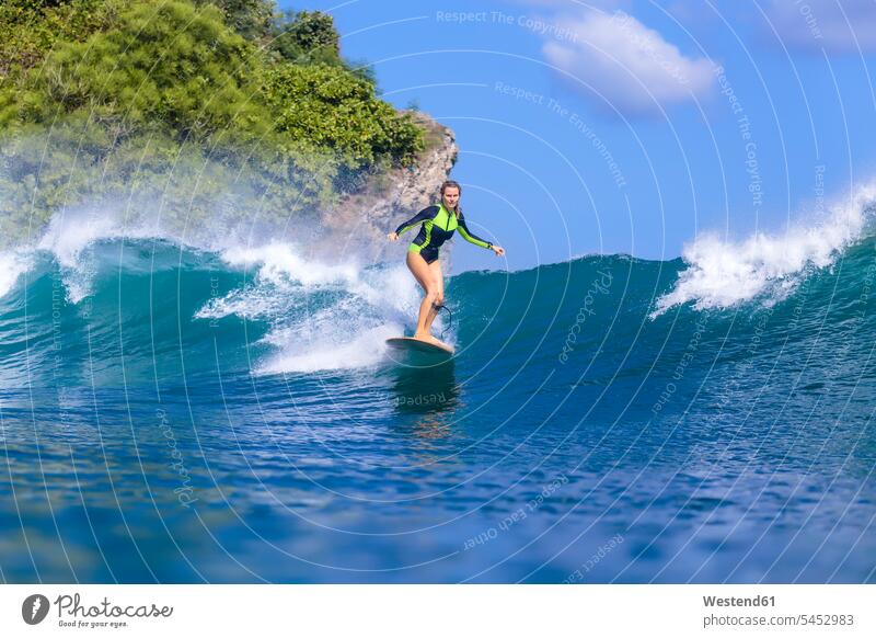 Indonesia, Bali, woman surfing females women surf ride surf riding Surfboarding wave waves Sea ocean Adults grown-ups grownups adult people persons human being