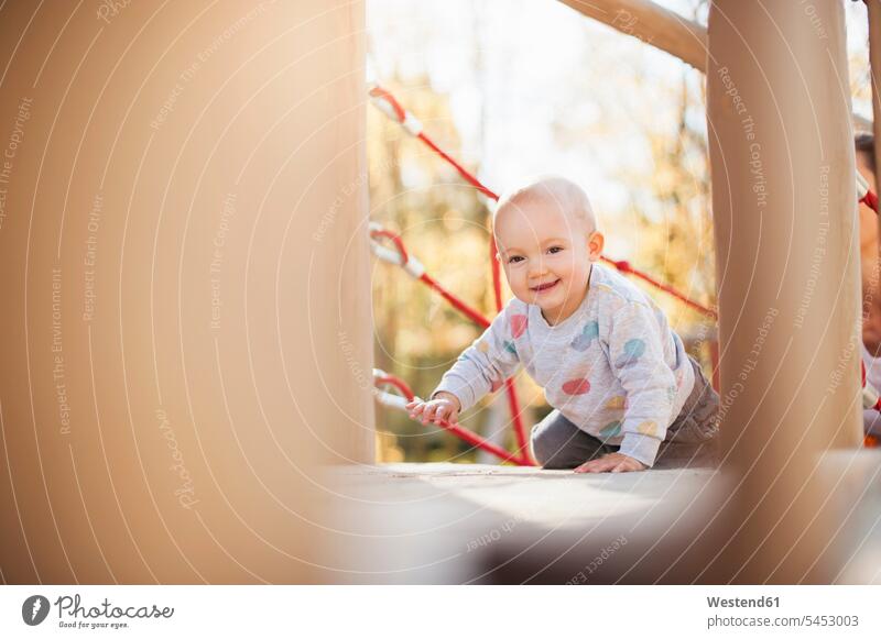 Portrait of happy baby girl on playground happiness play yard play ground playgrounds portrait portraits infants nurselings babies playing baby girls female
