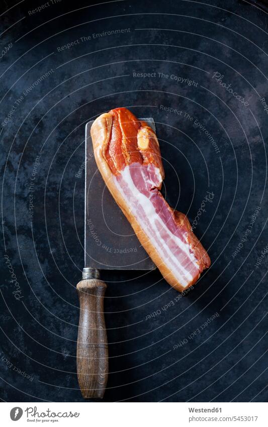 Streaky bacon with old cleaver on dark background overhead view from above top view Overhead Overhead Shot View From Above smoked streaky bacon cooking