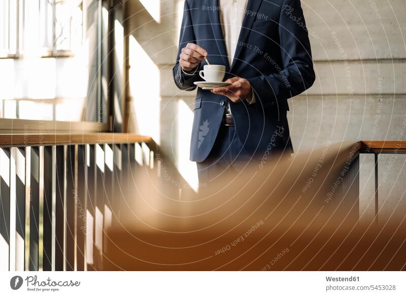 Businessman with cup of coffee in staircase window windows Business man Businessmen Business men Coffee business people businesspeople business world