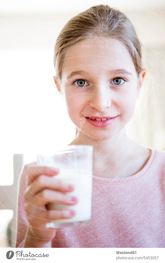 Portrait of smiling girl holding glass of milk females girls Milk smile child children kid kids people persons human being humans human beings Drink beverages
