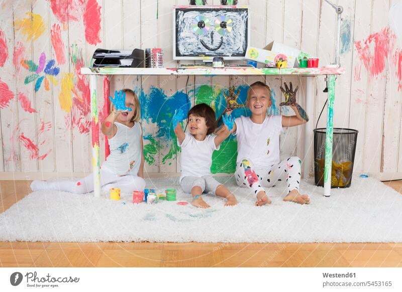 Three girls painting office with finger paint Fun having fun funny fingerpainting finger paints multi-coloured multicoloured multi colored Multi Coloured