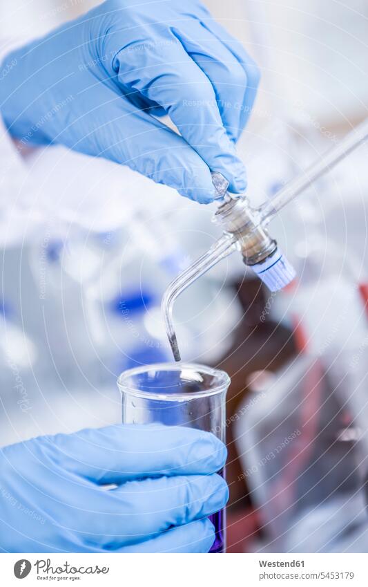 Close-up of scientist in lab working with liquid science sciences scientific sample swatch Swatches Samples laboratory beaker Glass Beaker beakers chemistry