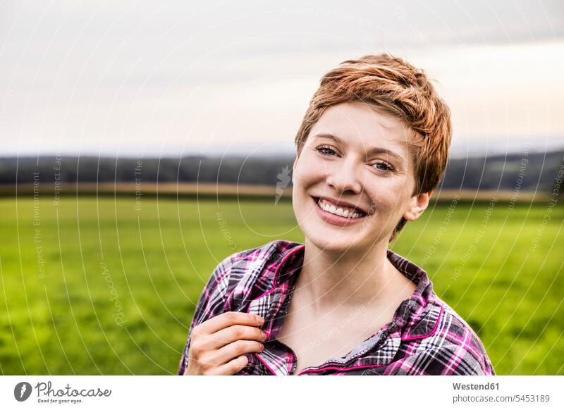 Portrait of smiling woman in pyjama in rural landscape portrait portraits landscapes scenery terrain smile females women Adults grown-ups grownups adult people